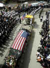 In 2002 the September 11th funerals, memorials, continue and the war on terror spreads across the world.